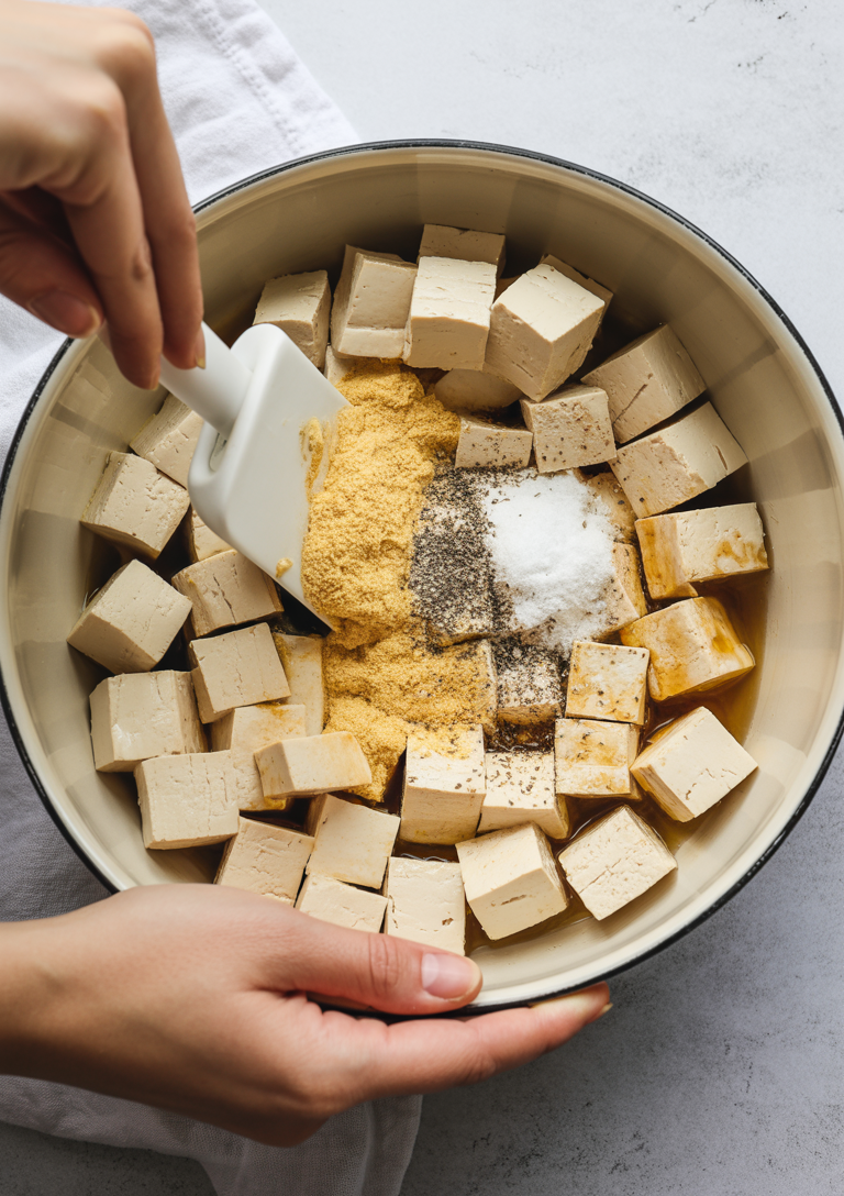 Coating the tofu cubes with cornstarch mixture ensures a crispy exterior